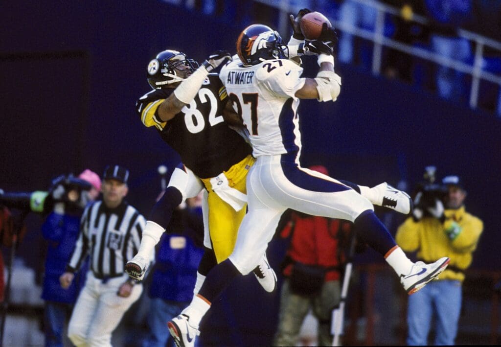Jan 11, 1998; Pittsburgh, PA, USA; FILE PHOTO; Denver Broncos free safety Steve Atwater (27) intercepts the pass over Pittsburgh Steelers wide receiver Yancy Thigpen (82) during the 1998 AFC Championship Game where Denver defeated Pittsburgh 24-21 at Three Rivers Stadium.