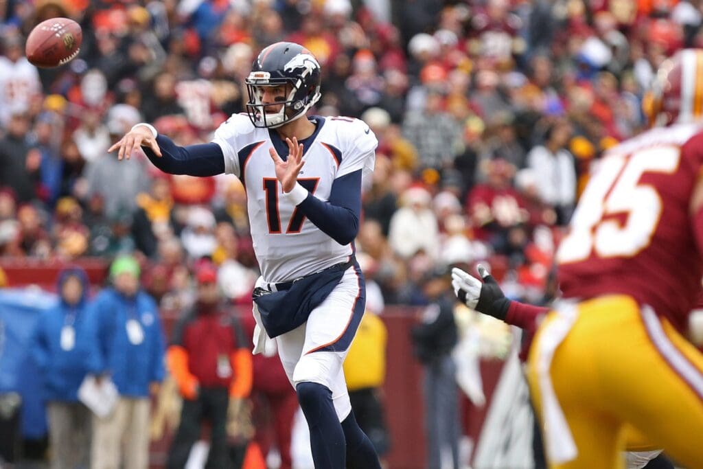 Dec 24, 2017; Landover, MD, USA; Denver Broncos quarterback Brock Osweiler (17) passes the ball in front of Washington Redskins linebacker Pete Robertson (45) in the first quarter at FedEx Field
