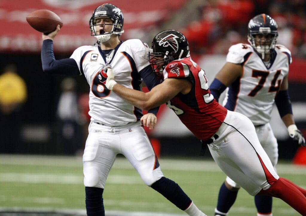 November 16, 2008; Atlanta, GA USA; Denver Broncos quarterback Jay Cutler (6) releases the ball as he is hit by Atlanta Falcons defensive end Jamaal Anderson (98) in the first half at the Georgia Dome.