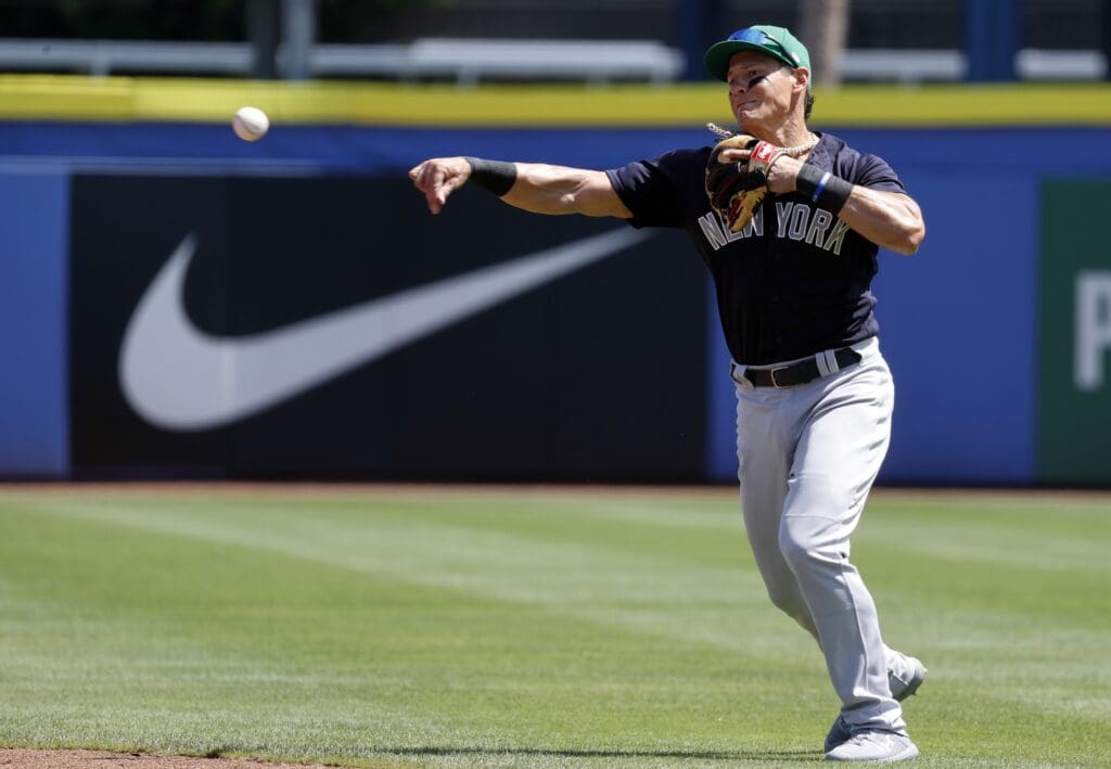 Mar 17, 2021; Dunedin, Florida, USA; New York Yankees infielder Derek Dietrich (12) throws the ball for an out during the second inning against the Toronto Blue Jays at TD Ballpark.