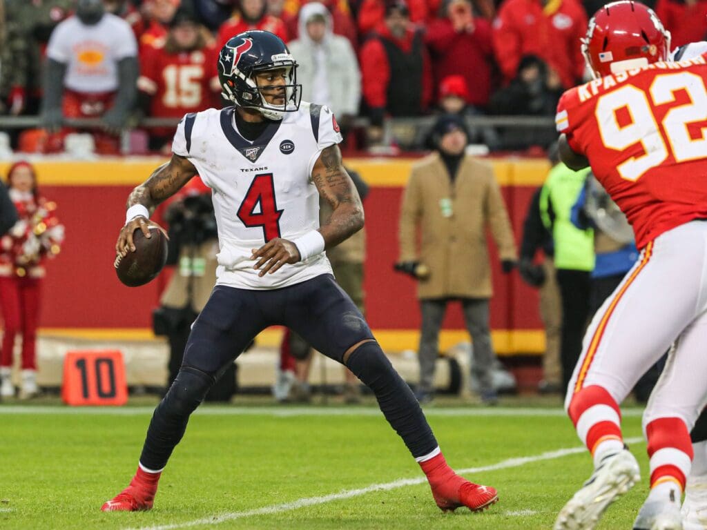 Jan 12, 2020; Kansas City, Missouri, USA; Houston Texans quarterback Deshaun Watson (4) throws a pass as Kansas City Chiefs defensive end Tanoh Kpassagnon (92) defends during the second half in a AFC Divisional Round playoff football game at Arrowhead Stadium.