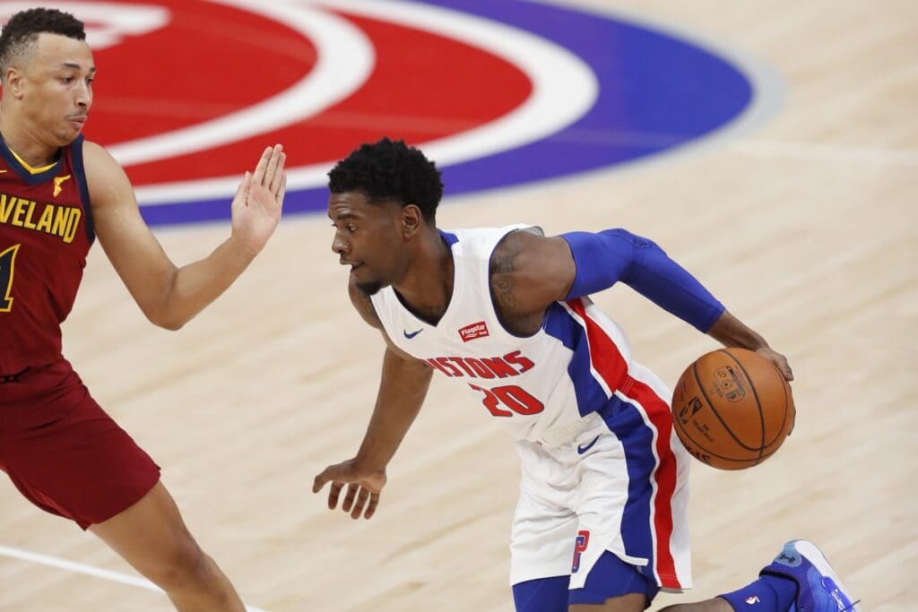 Dec 26, 2020; Detroit, Michigan, USA; Detroit Pistons forward Josh Jackson (20) drives to the basket against Cleveland Cavaliers guard Dante Exum (1) during the first quarter at Little Caesars Arena.