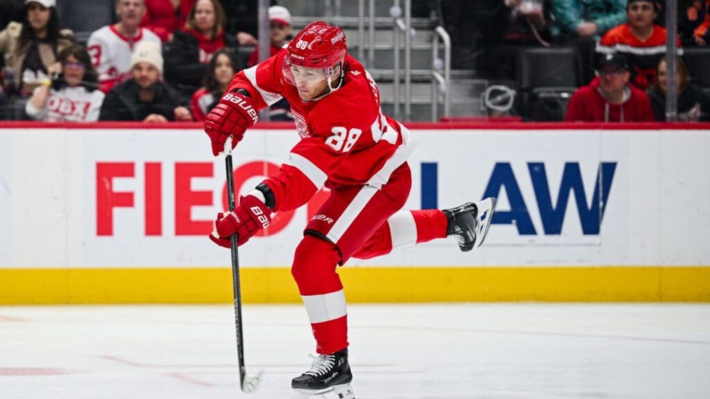 Apr 4, 2025; Detroit, Michigan, USA; Detroit Red Wings right wing Patrick Kane (88) shoots and scores a goal during the second period against the Carolina Hurricanes at Little Caesars Arena.