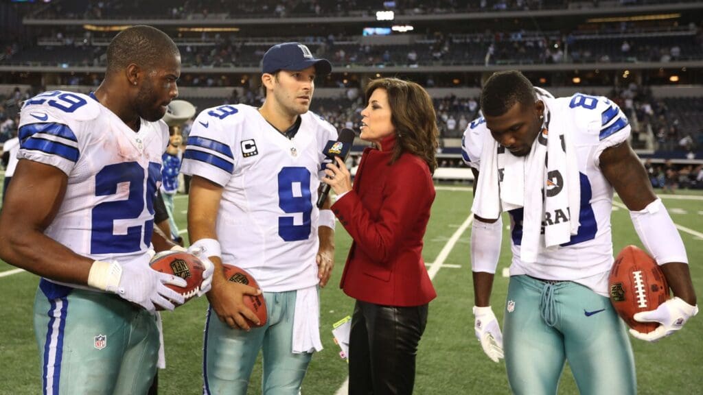 Dec 2, 2012; Arlington, TX, USA; NBC sideline reporter Michelle Tafoya interviews Dallas Cowboys quarterback Tony Romo (9) running back DeMarco Murray (29) and receiver Dez Bryant (88) against the Philadelphia Eagles at Cowboys Stadium. The Cowboys beat the Eagles 38-33.