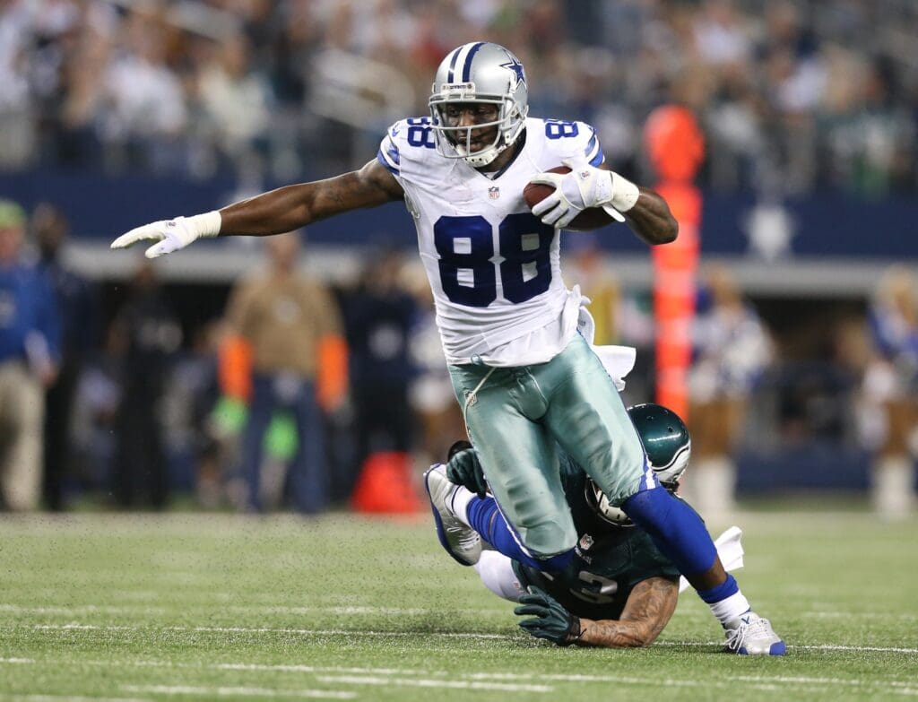 Dec 29, 2013; Arlington, TX, USA; Dallas Cowboys receiver Dez Bryant (88) runs after a reception for a fourth quarter touchdown against Philadelphia Eagles safety Patrick Chung (23) at AT&T Stadium. The Eagle beat the Cowboys 24-22.