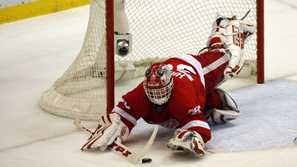 April 6, 2008; Detroit, MI, USA; Detroit Red Wings goalie Dominik Hasek (39) dives for the puck in the first period against the Chicago Black Hawks at Joe Louis Arena.