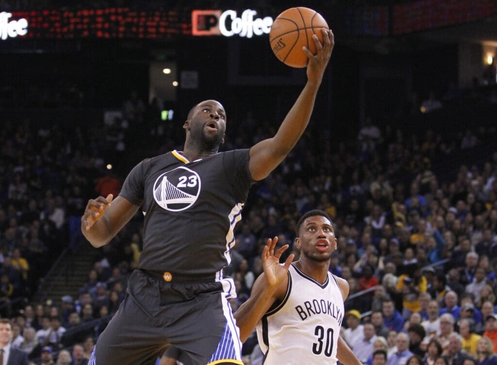 Nov 14, 2015; Oakland, CA, USA; Golden State Warriors forward Draymond Green (23) catches a pass in front of Brooklyn Nets forward Thaddeus Young (30) in the second quarter at Oracle Arena.