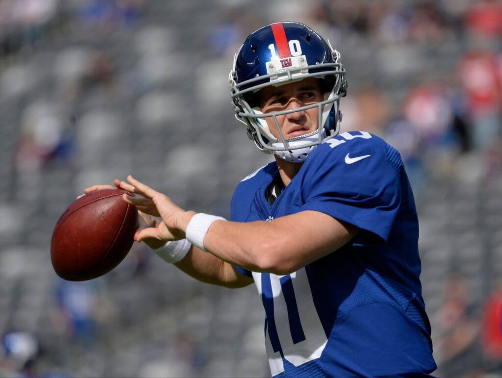 Sep 15, 2013; East Rutherford, NJ, USA; New York Giants quarterback Eli Manning (10) warms up before the game against the Denver Broncos at MetLife Stadium.