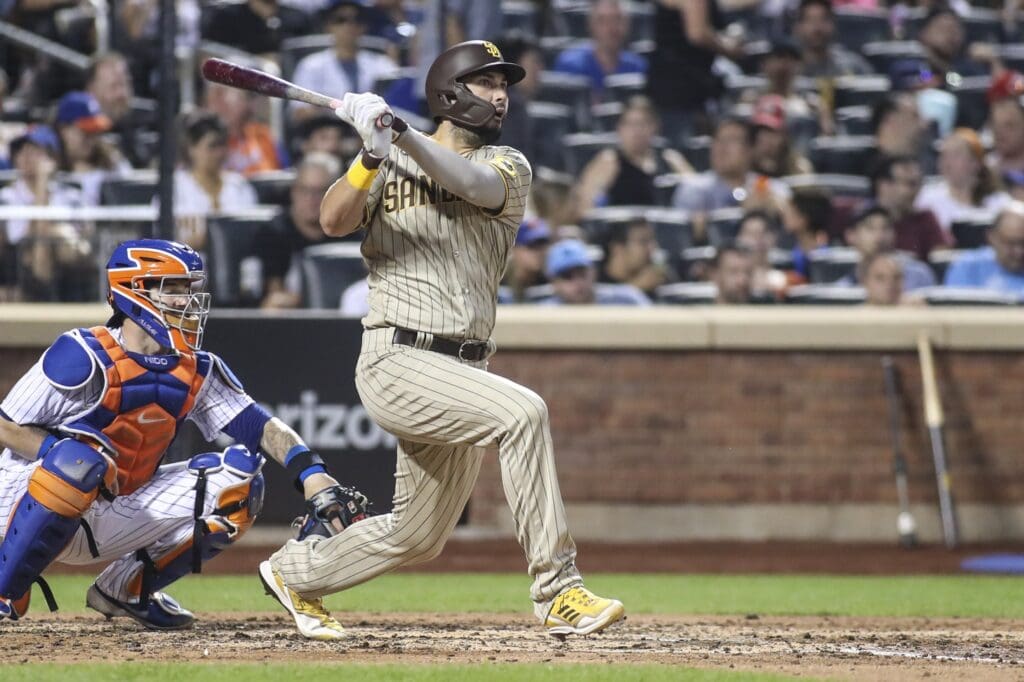 Jul 23, 2022; New York City, New York, USA; San Diego Padres first baseman Eric Hosmer (30) hits a single against the New York Mets in the fifth inning at Citi Field.