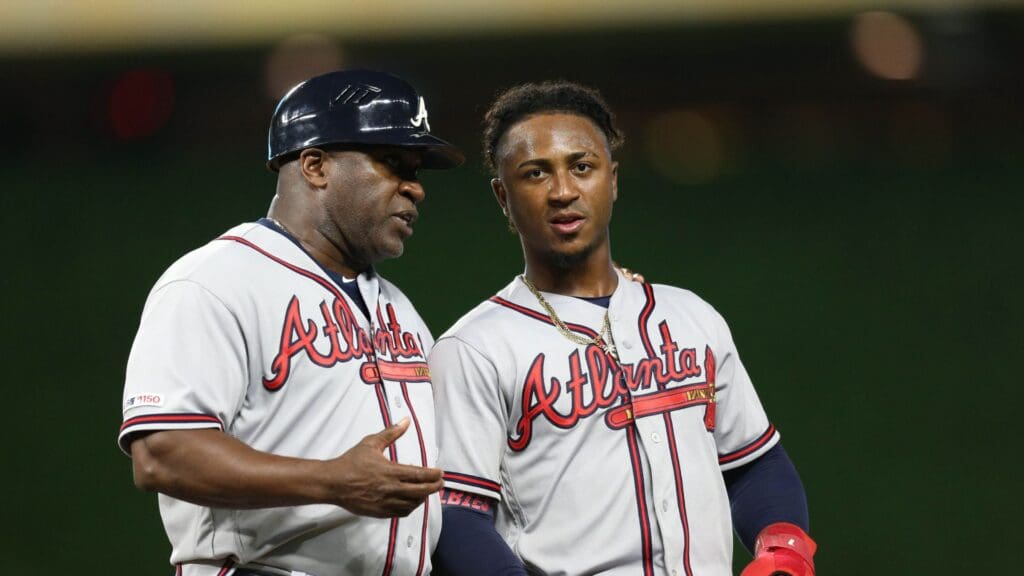 Aug 5, 2019; Minneapolis, MN, USA; Atlanta Braves second baseman Ozzie Albies (right) speaks with Atlanta Braves first base coach Eric Young Sr. (left) during the seventh inning against the Minnesota Twins at Target Field.