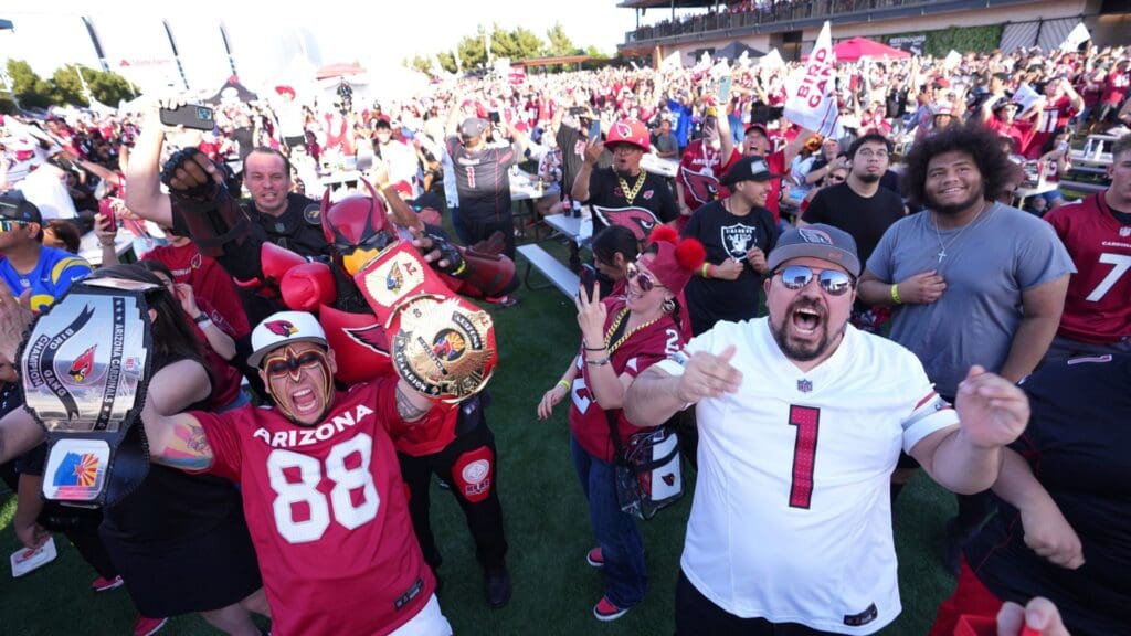 Fans celebrate the Arizona Cardinals pick of Marvin Harrison Jr. during an NFL Draft party at State Farm Stadium Great Lawn in Glendale on April 25, 2024.