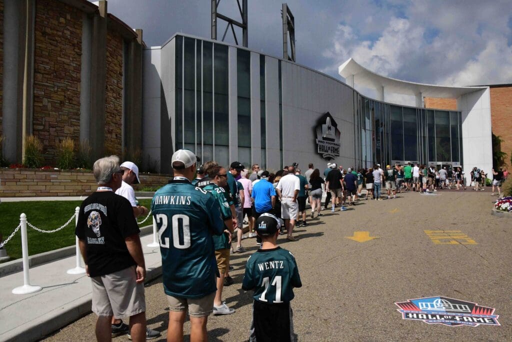 Aug 4, 2018; Canton, OH, USA; Fans wearing Philadelphia Eagles jerseys of safety Brian Dawkins (20) and quarterback Carson Wentz (20) stand outside of the Pro Football Hall of Fame. 