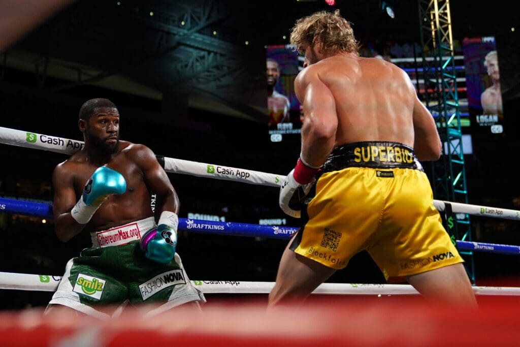 Jun 6, 2021; Miami, Florida, USA; Floyd Mayweather Jr. (Green Trunks) fights Logan Paul (Yellow Trunks) during an exhibition boxing match at Hard Rock Stadium.