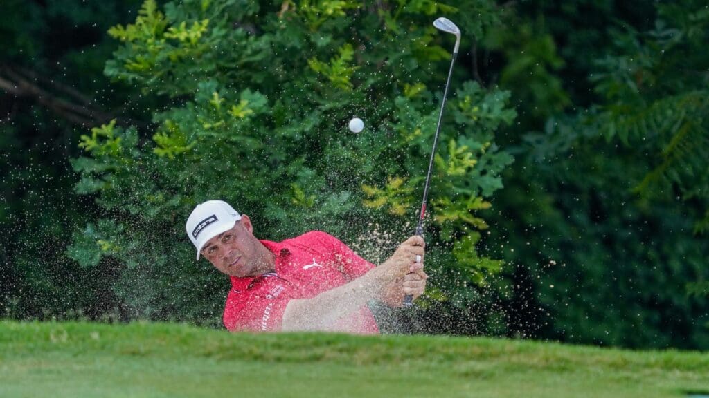 May 24, 2025; Fort Worth, Texas, USA; Gary Woodland plays a shot from a bunker on the 11th hole during the third round of the Charles Schwab Challenge golf tournament.