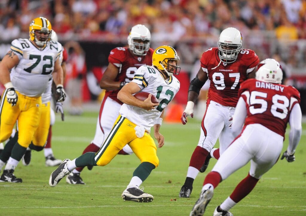 Aug. 28, 2009; Glendale, AZ, USA; Green Bay Packers quarterback (12) Aaron Rodgers runs the ball in the first half against the Arizona Cardinals during a preseason game at University of Phoenix Stadium.
