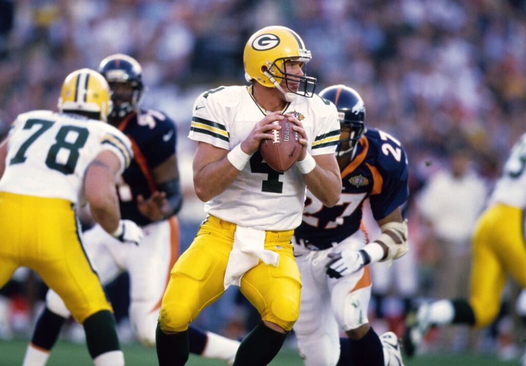 Jan 25, 1998; San Diego, CA, USA; FILE PHOTO; Green Bay Packers quarterback Brett Favre (4) looks to throw against Denver Broncos safety Steve Atwater (27) during Super Bowl XXXII at Qualcomm Stadium. The Broncos defeated the Packers 31-24.