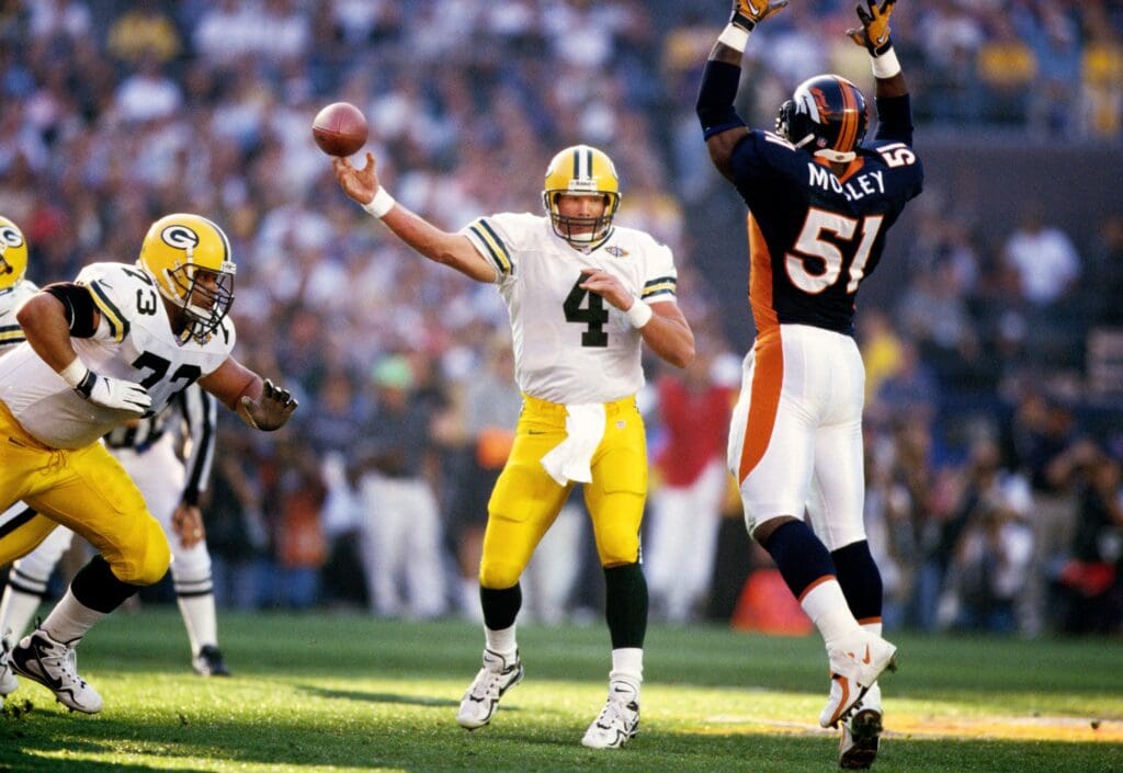Jan 25, 1998; San Diego, CA, USA; FILE PHOTO; Green Bay Packers quarterback Brett Favre (4) throws under pressure from Denver Broncos linebacker John Mobley (51) during Super Bowl XXXII at Qualcomm Stadium. The Broncos defeated the Packers 31-24.