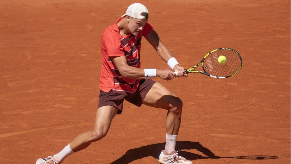 May 30, 2025; Paris, FR; Holger Rune of Denmark returns a shot during his match against Quentin Halys of France on day six at Roland Garros Stadium.