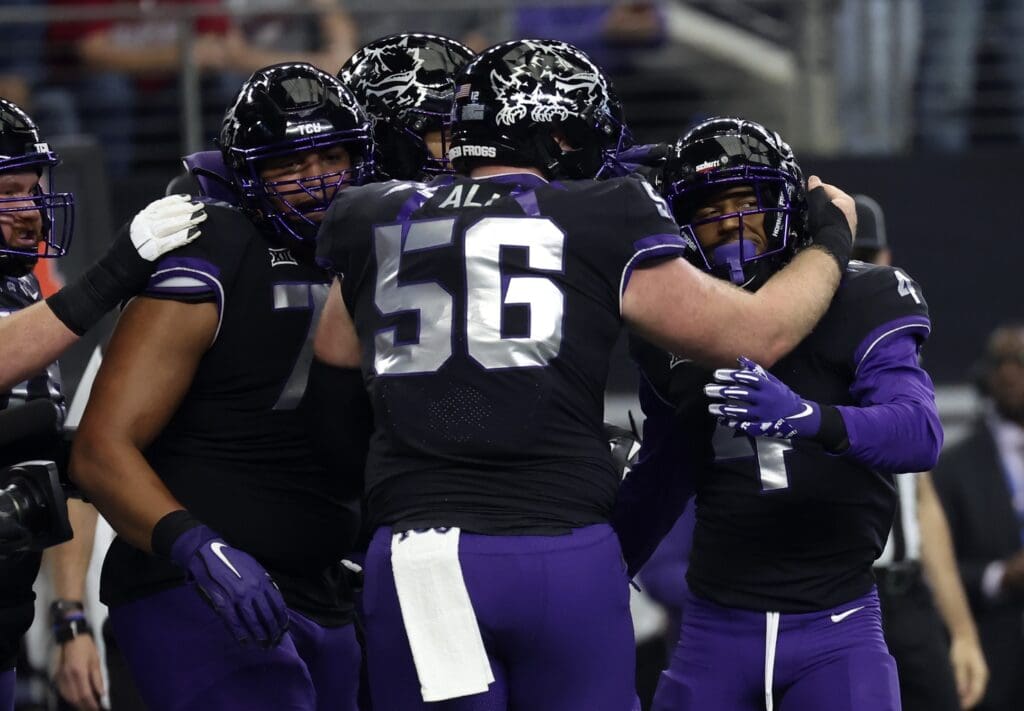 Dec 3, 2022; Arlington, TX, USA; TCU Horned Frogs wide receiver Taye Barber (4) celebrates with teammates after scoring a touchdown during the first quarter against the Kansas State Wildcats at AT&T Stadium.