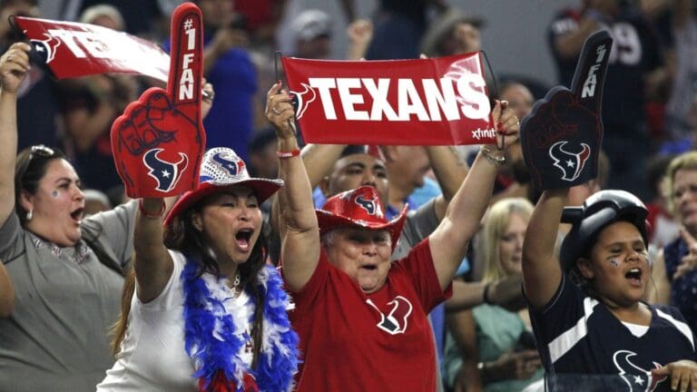 Sep 3, 2015; Arlington, TX, USA; Houston Texans fans celebrate a touchdown in the second quarter against the Dallas Cowboys at AT&T Stadium