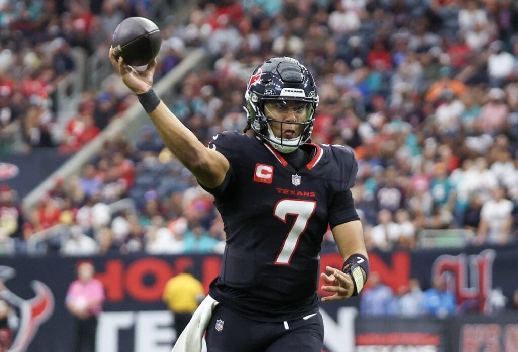 Dec 15, 2024; Houston, Texas, USA; Houston Texans quarterback C.J. Stroud (7) throws a touchdown against the Miami Dolphins in the third quarter at NRG Stadium.