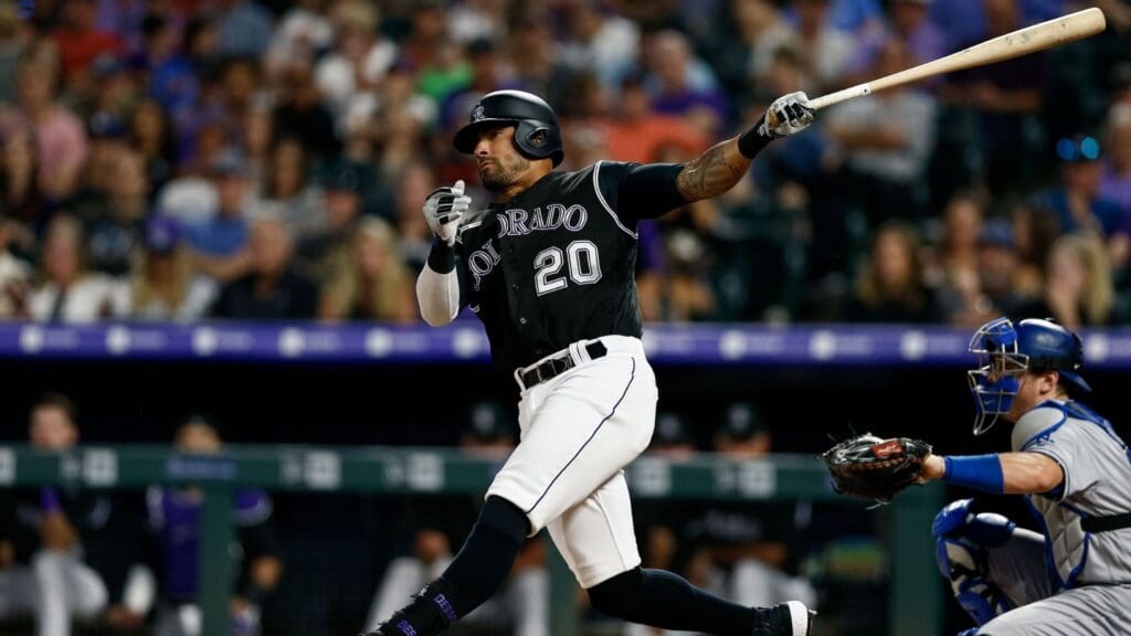 Jul 29, 2019; Denver, CO, USA; Colorado Rockies left fielder Ian Desmond (20) watches his ball on a double in the sixth inning against the Los Angeles Dodgers at Coors Field.