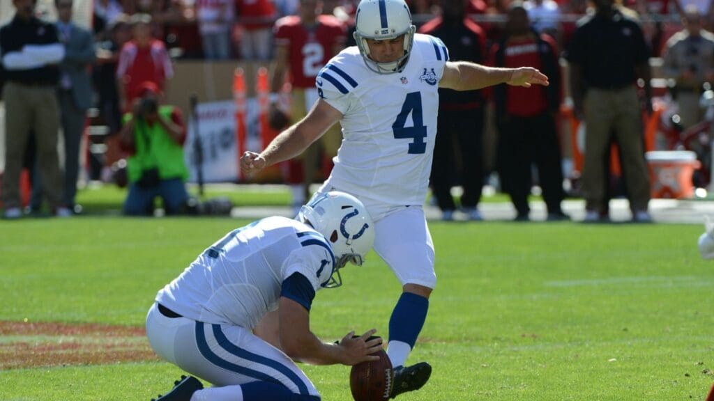 September 22, 2013; San Francisco, CA, USA; Indianapolis Colts kicker Adam Vinatieri (4) kicks the football out of the hold by punter Pat McAfee (1) during the fourth quarter against the San Francisco 49ers at Candlestick Park. The Colts defeated the 49ers 27-7.