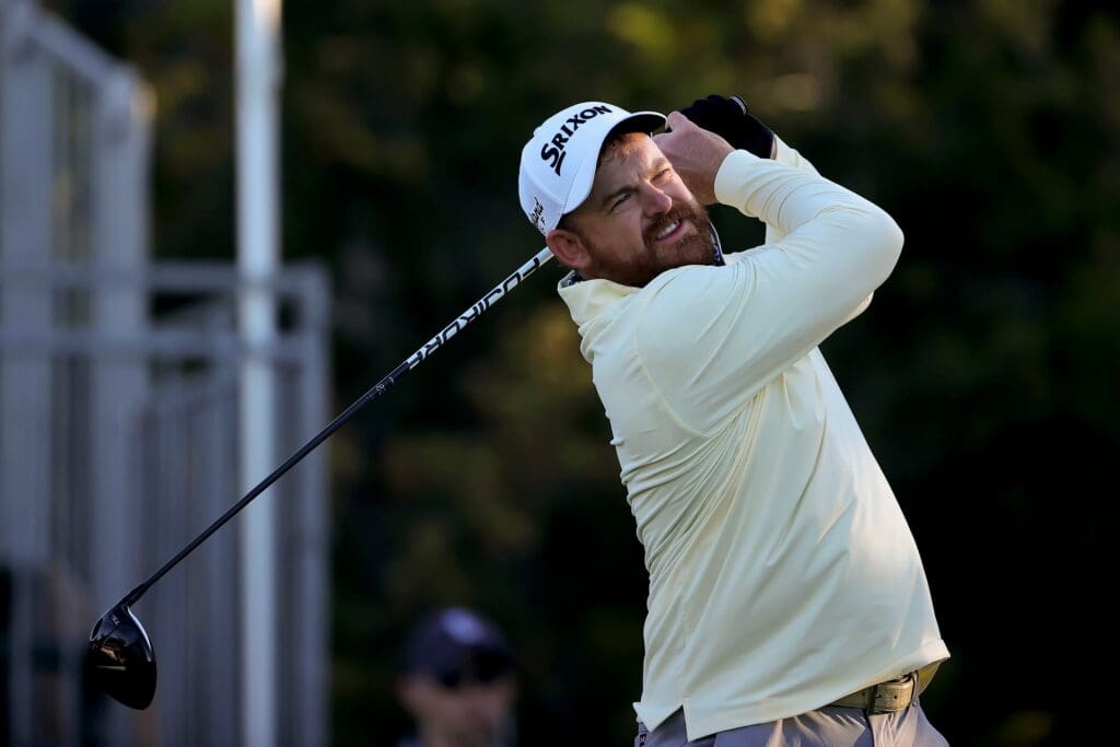 J.B. Holmes hits a tee shot on the first hole during the first round of the Valero Texas Open golf tournament.