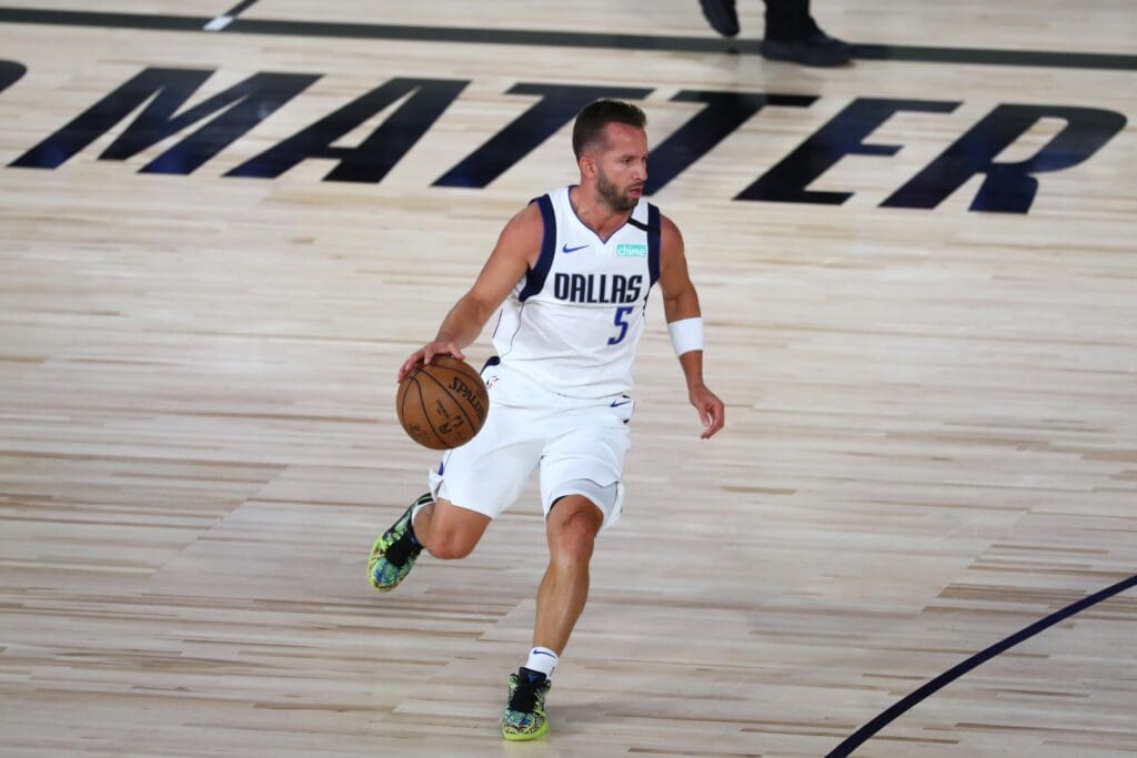 Aug 4, 2020; Lake Buena Vista, Florida, USA; Dallas Mavericks guard J.J. Barea (5) brings the ball upcourt against the Sacramento Kings during the first half of a NBA basketball game in the HP Field House at the ESPN Wide World of Sports Complex.
