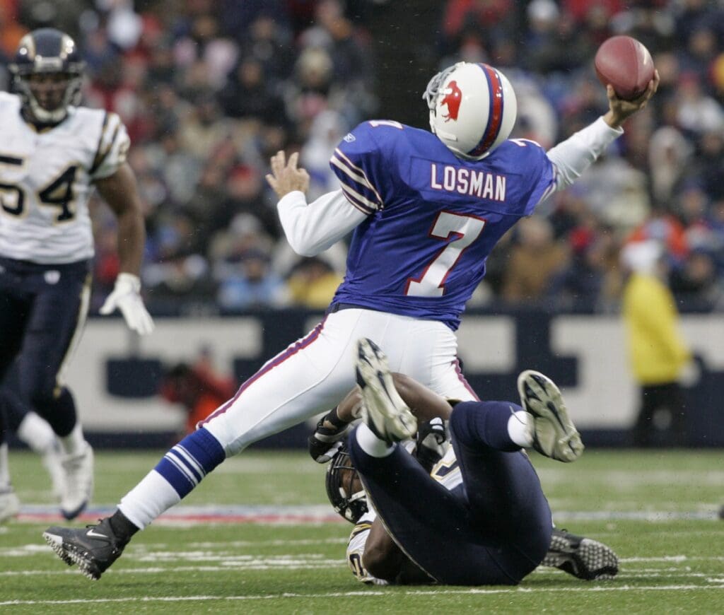 December 3, 2006; Orchard Park, NY, USA; Buffalo Bills quarterback (7) J.P. Losman is brought down by San Diego Chargers linebacker (95) Shaun Phillips during the second quarter at Ralph Wilson Stadium.