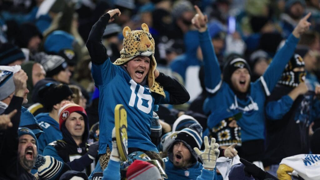 Jacksonville Jaguars fans celebrate Jacksonville Jaguars quarterback Trevor Lawrence (16) two point conversion during the fourth quarter of an NFL first round playoff football matchup Saturday, Jan. 14, 2023 at TIAA Bank Field in Jacksonville, Fla. Jacksonville Jaguars edged the Los Angeles Chargers on a field goal 31-30.