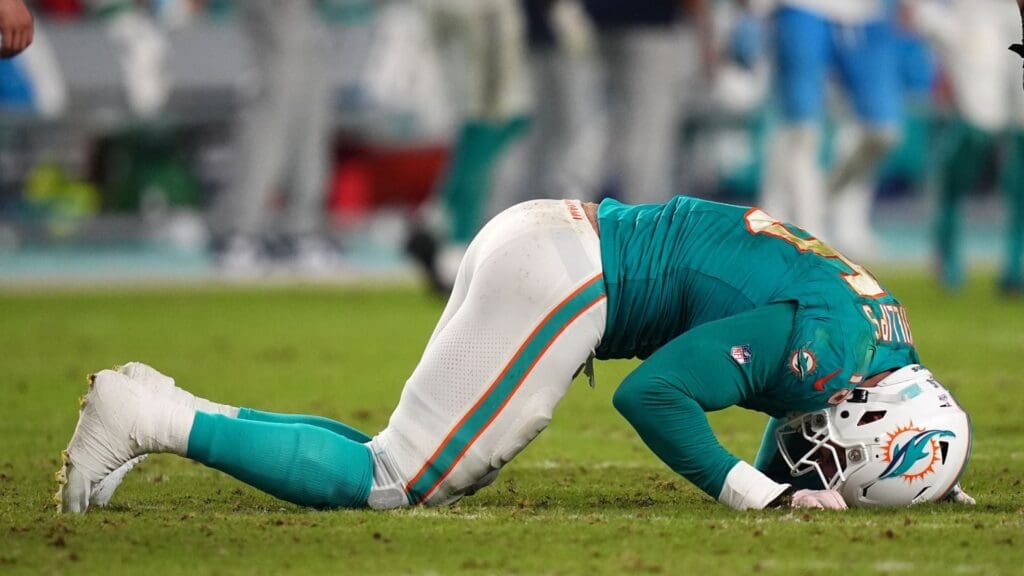 Sep 30, 2024; Miami Gardens, Florida, USA; Miami Dolphins linebacker Jaelan Phillips (15) reacts after an apparent injury during the second half against the Tennessee Titans at Hard Rock Stadium.