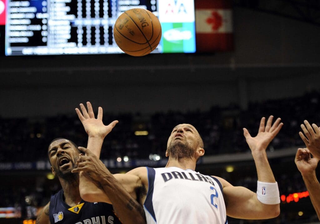 Mar 6, 2011; Dallas, TX, USA; Dallas Mavericks point guard Jason Kidd (2) fights for his own rebound against Memphis Grizzlies point guard Mike Conley (11) during the second half at the American Airlines Center. The Grizzlies defeated the Mavericks 104-103.