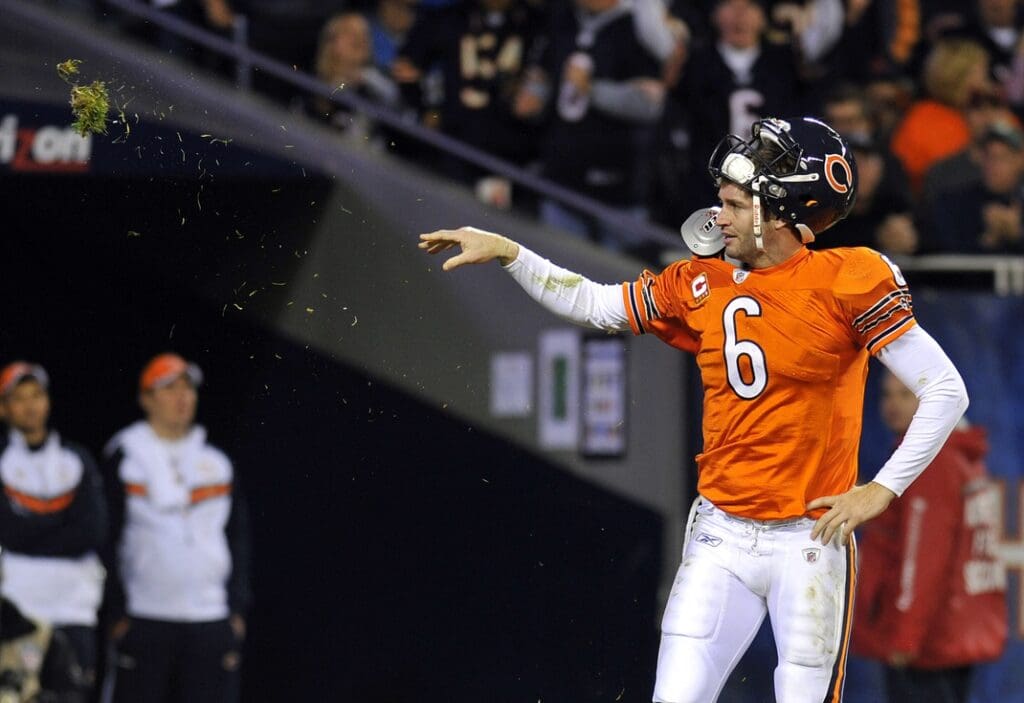 Nov 13, 2011; Chicago, IL, USA; Chicago Bears quarterback Jay Cutler (6) throws a chunk of grass after being hit by a Detroit Lions defender in the fourth quarter at Soldier Field. The Bears defeat the Lions 37-13.