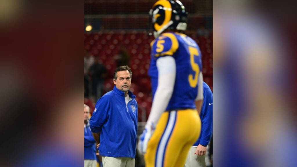 Dec 6, 2015; St. Louis, MO, USA; St. Louis Rams head coach Jeff Fisher looks on as quarterback Nick Foles (5) warms up before a game against the Arizona Cardinals at the Edward Jones Dome.