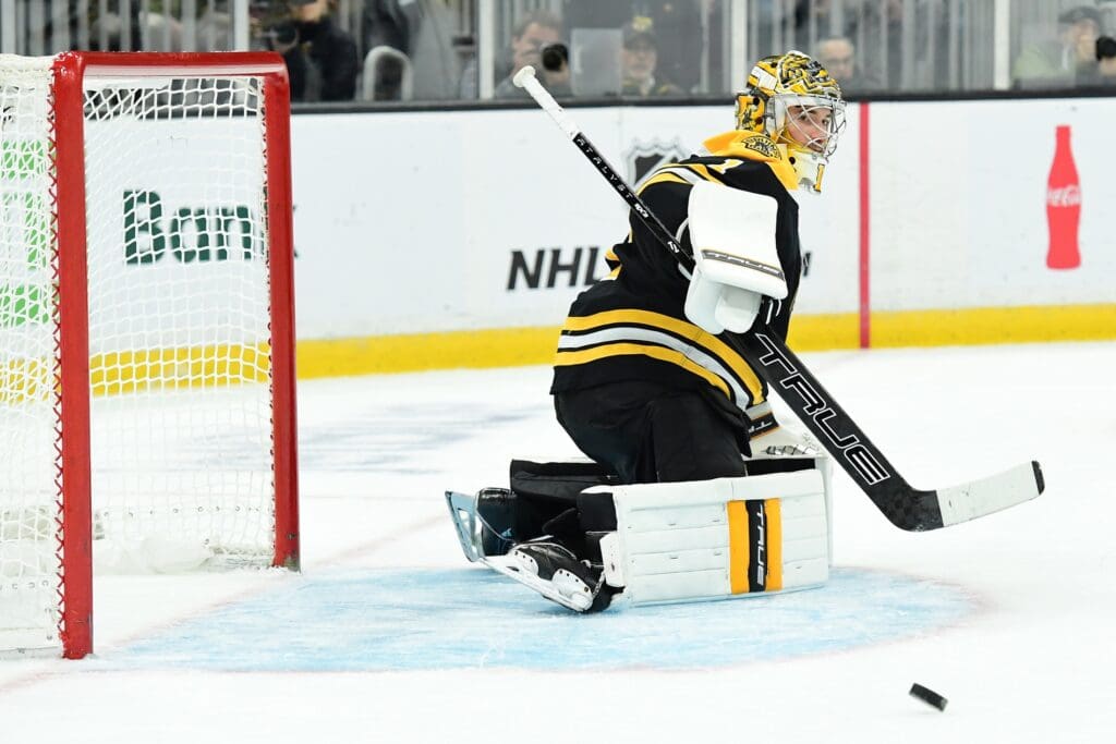 Apr 10, 2025; Boston, Massachusetts, USA; Boston Bruins goaltender Jeremy Swayman (1) steers the puck towards the boards during the second period against the Chicago Blackhawks at TD Garden.