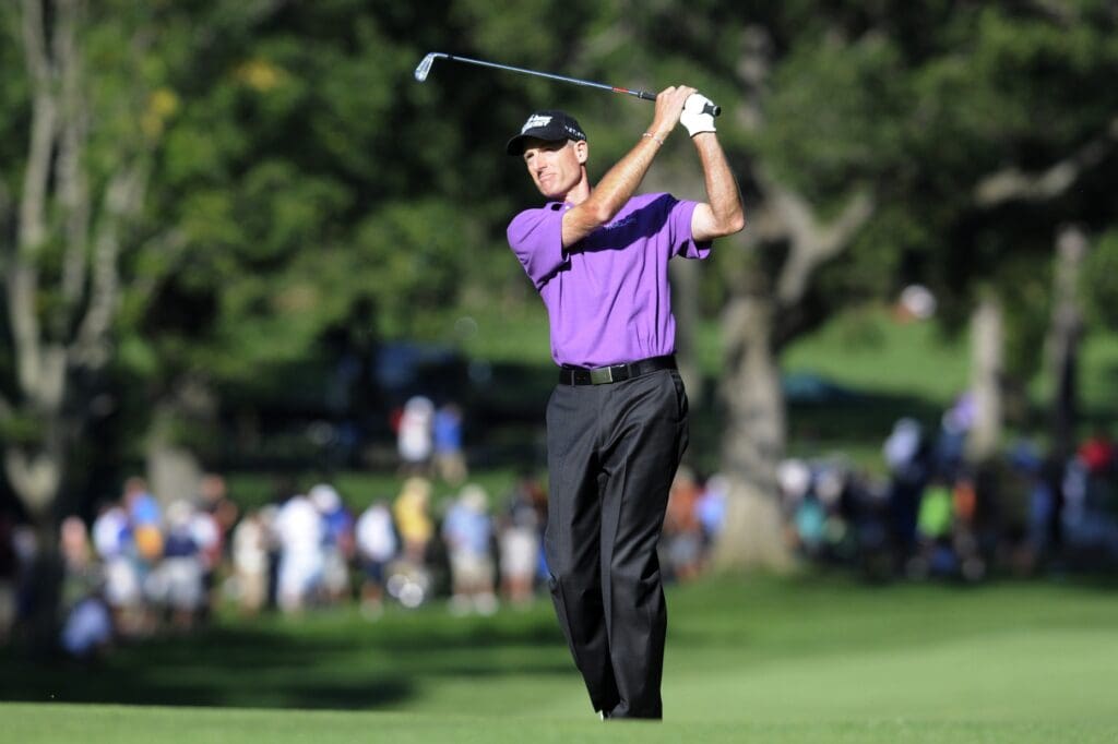 Jim Furyk hits his approach shot into the 13th green during the third round of the 95th PGA Championship at Oak Hill Country Club..