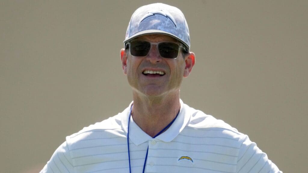 May 20, 2025; El Segundo, CA, USA; Los Angeles Chargers coach Jim Harbaugh looks on during offseason workouts at The Bolt