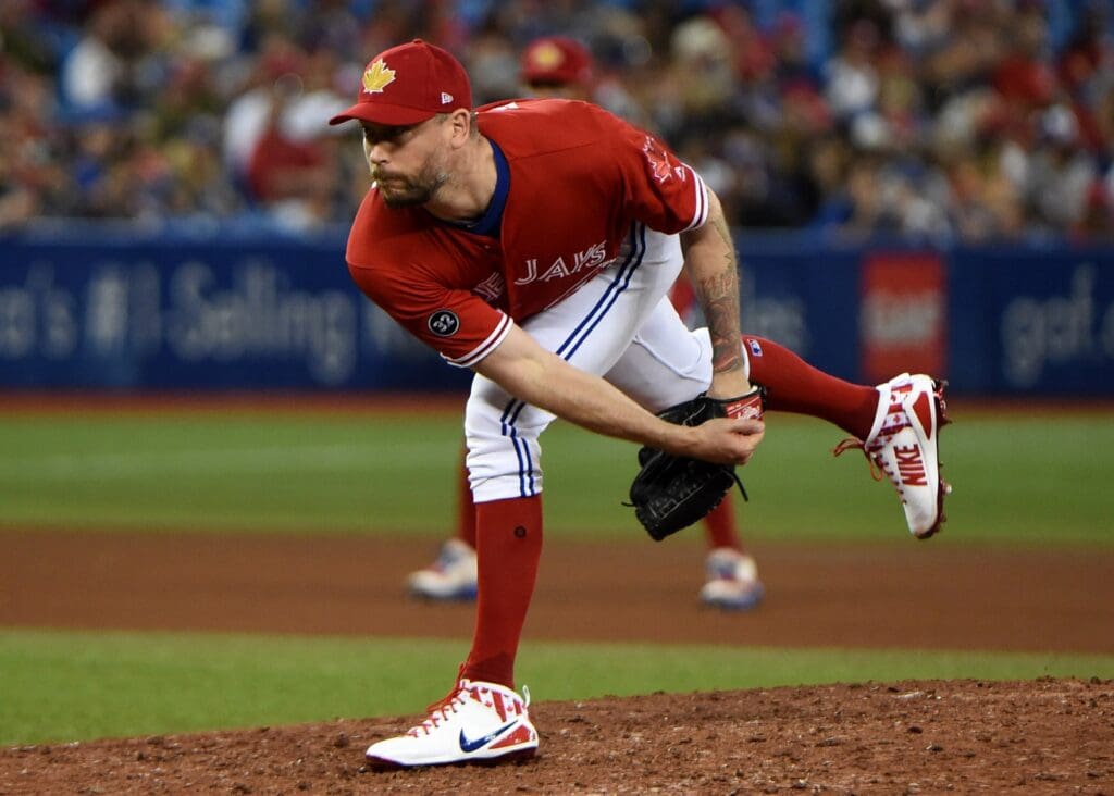 Jul 1, 2018; Toronto, Ontario, CAN; Toronto Blue Jays relief pitcher John Axford (77) delivers a pitch against Detroit Tigers in the seventh inning at Rogers Centre.