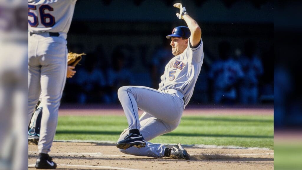 1999, Miami, FL, USA; FILE PHOTO; New York Mets first baseman John Olerud slides into home against the Florida Marlins at Dolphin Stadium during the 1999 season.