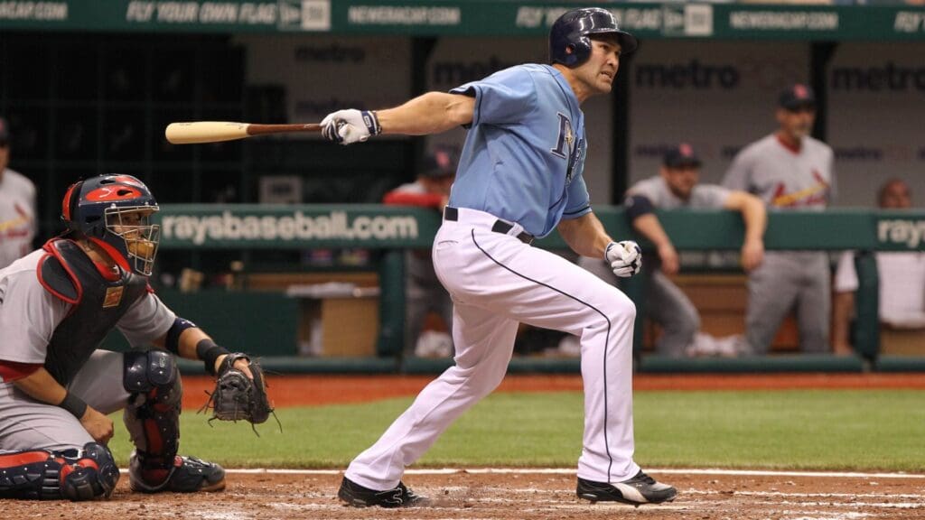 July 3, 2011; St. Petersburg, FL, USA;Tampa Bay Rays designated hitter Johnny Damon (right) hits an RBI double in the fifth inning against the St. Louis Cardinals at Tropicana Field.