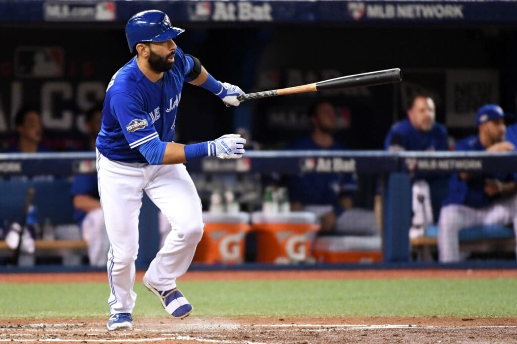 Oct 19, 2016; Toronto, Ontario, CAN; Toronto Blue Jays right fielder Jose Bautista (19) hits a single during the sixth inning against the Cleveland Indians in game five of the 2016 ALCS playoff baseball series at Rogers Centre.
