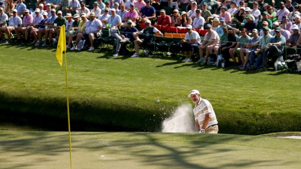 Apr 10, 2025; Augusta, Georgia, USA; Jose Maria Olazabal hits out of a bunker on no. 16 during the first round of the Masters Tournament.