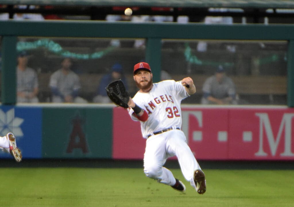 Oct 2, 2014; Anaheim, CA, USA; Los Angeles Angels left fielder Josh Hamilton (32) makes a sliding catch during the second inning in game one of the 2014 American League divisional series against the Kansas City Royals at Angel Stadium of Anaheim