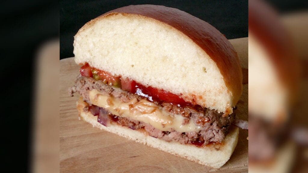 Juicy Lucy in a brioche bun with onion, tomato and ketchup
