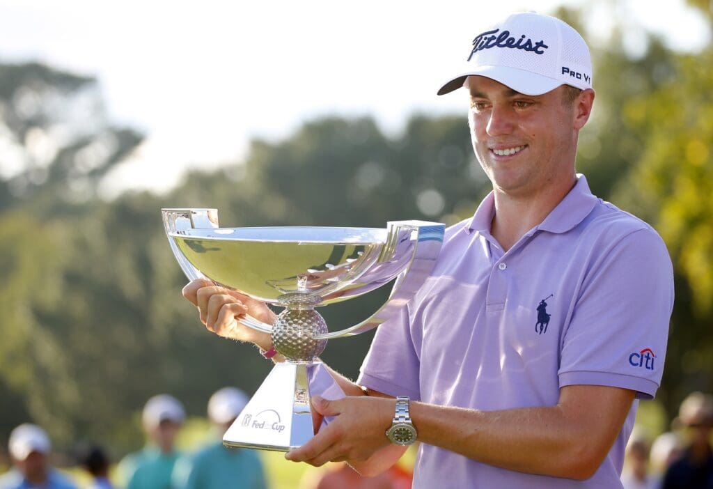 Sep 24, 2017; Atlanta, GA, USA; Justin Thomas hoists the trophy after winning the FedEx Cup following the Tour Championship golf tournament at East Lake Golf Club.