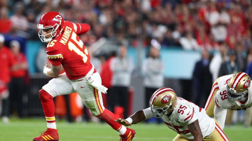 Feb 2, 2020; Miami Gardens, Florida, USA; Kansas City Chiefs quarterback Patrick Mahomes (15) runs away from San Francisco 49ers defensive end Dee Ford (55) in the second half in Super Bowl LIV at Hard Rock Stadium