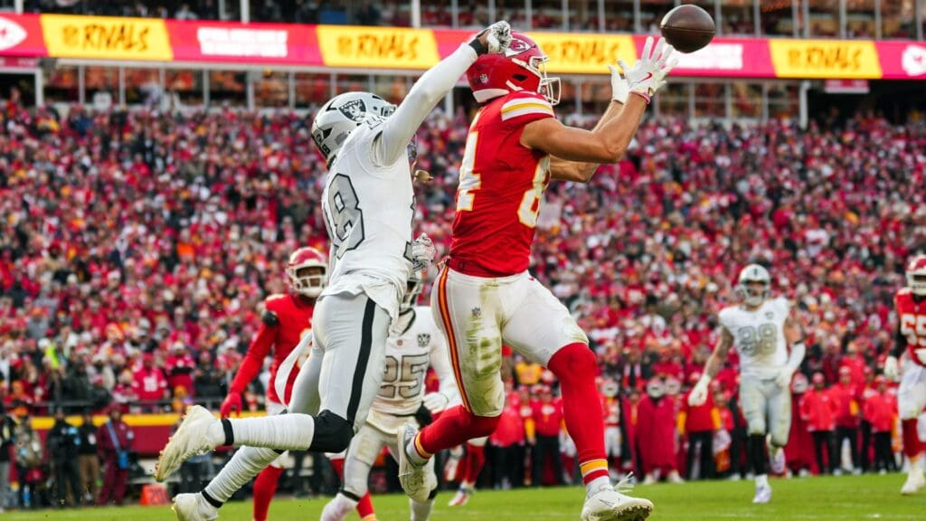 Nov 29, 2024; Kansas City, Missouri, USA; Kansas City Chiefs wide receiver Justin Watson (84) catches a touchdown pass against Las Vegas Raiders cornerback Jack Jones (18) during the first half at GEHA Field at Arrowhead Stadium