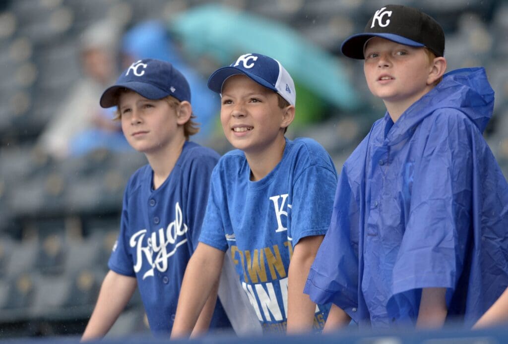 May 7, 2015; Kansas City, MO, USA; Young Royals fans brave the the rain to view the field as the game between the Kansas City Royals and Cleveland Indians is delayed at Kauffman Stadium.