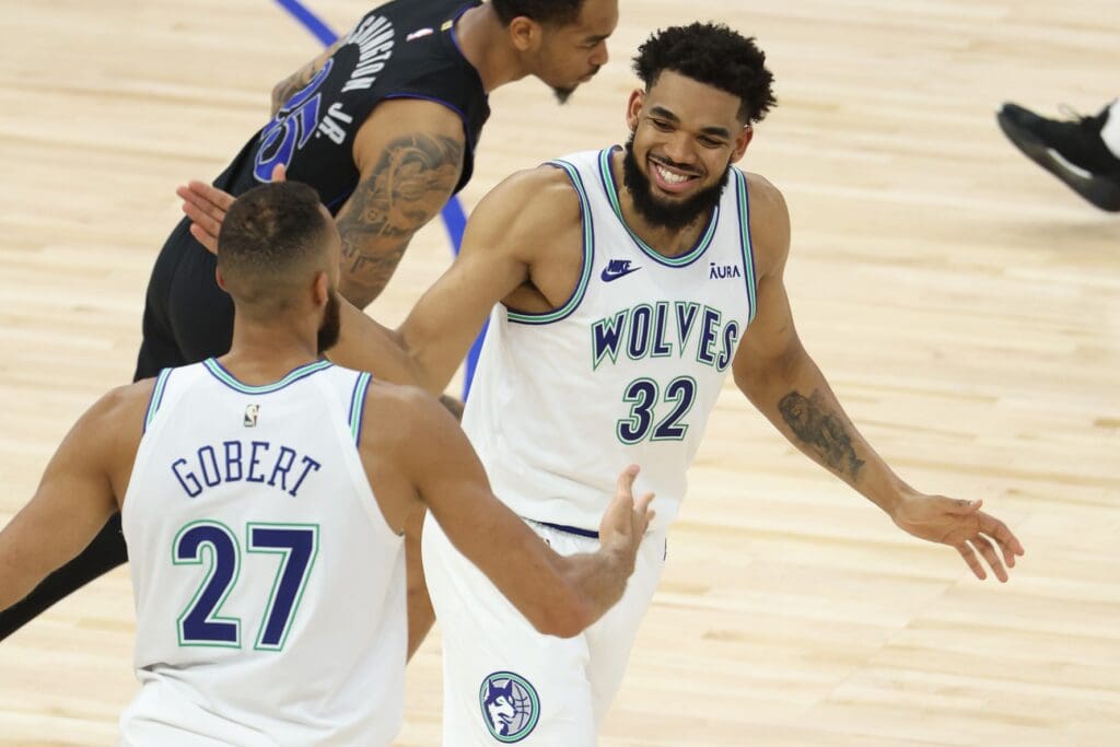 May 24, 2024; Minneapolis, Minnesota, USA; Minnesota Timberwolves center Karl-Anthony Towns (32) and center Rudy Gobert (27) react in the third quarter against the Dallas Mavericks during game two of the western conference finals for the 2024 NBA playoffs at Target Center.